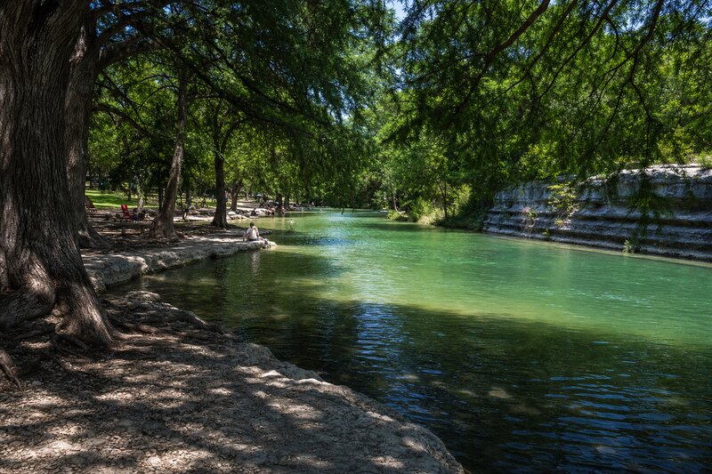 A contextual cypress-shaded Medina River bank near Bandera