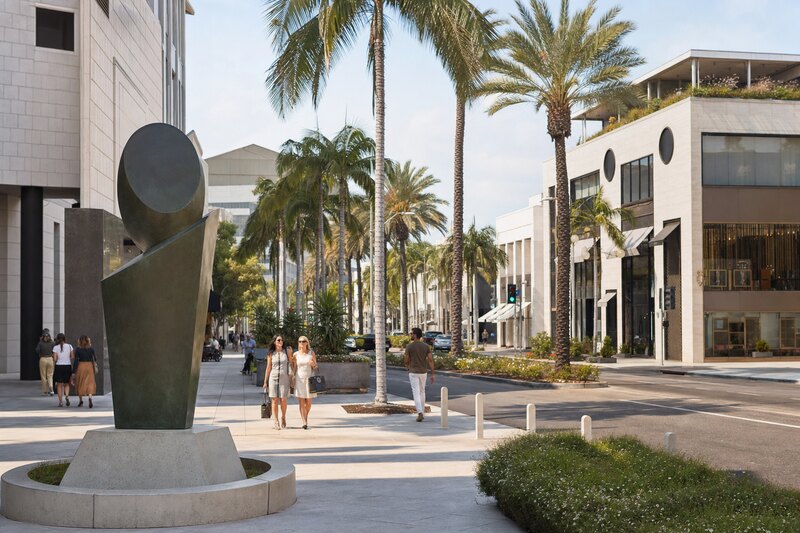 Palm-lined shopping district with contemporary public art