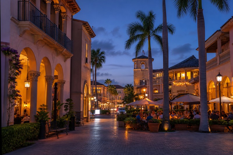 Mizner Park style arcades and palm-lined evening in Boca Raton