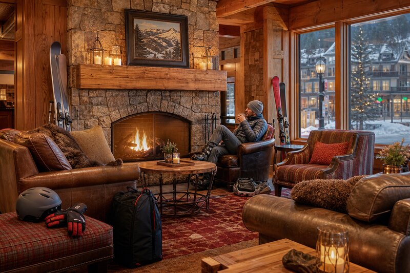 Cozy Breckenridge lodge lounge with fireplace and ski gear