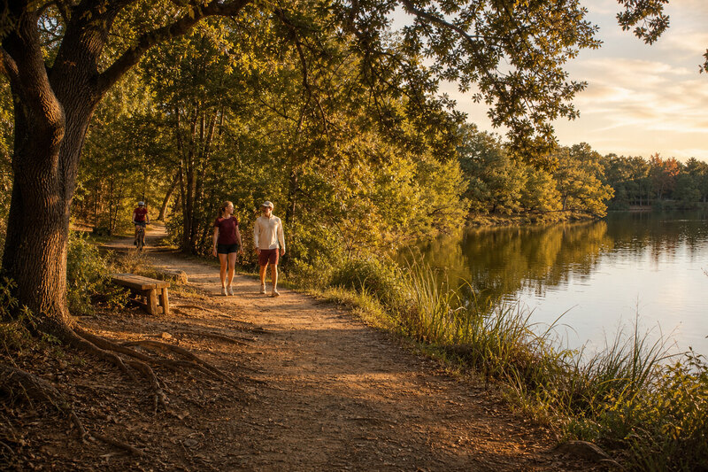 Contextual lakeside recreation trail near Bryan at sunset
