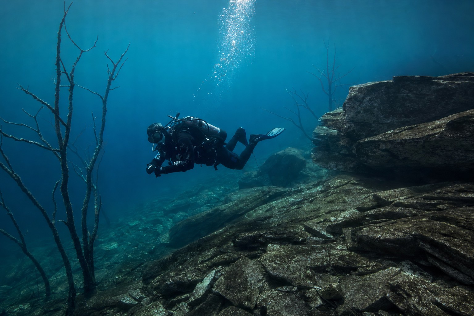 Prepared freshwater scuba diver in clear mountain-lake water