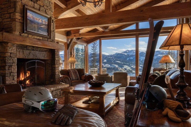 Cozy Purgatory lodge lounge with fireplace and ski gear
