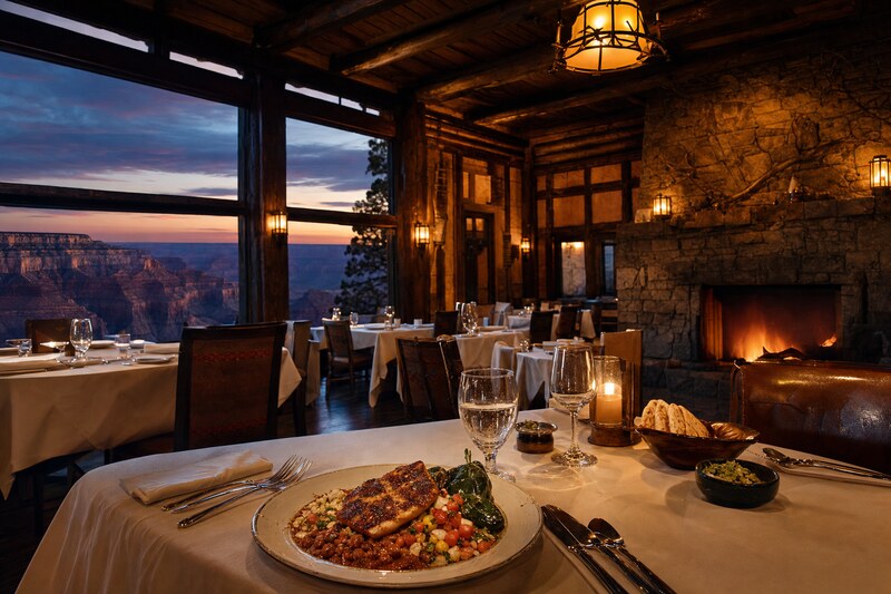 A warm timber-and-stone lodge dining room near the canyon rim