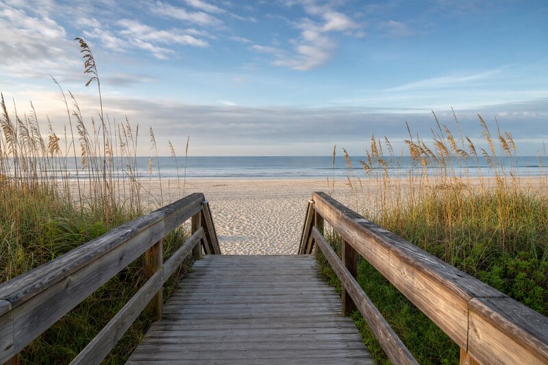 Wooden boardwalk through sea oats to a wide Hilton Head beach