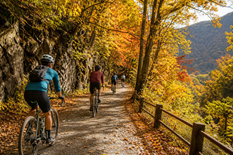 Cyclists on the Lehigh Gorge rail trail beside the river