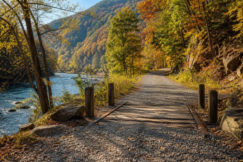 D&L Trail bridge beside the Lehigh River beneath wooded gorge walls