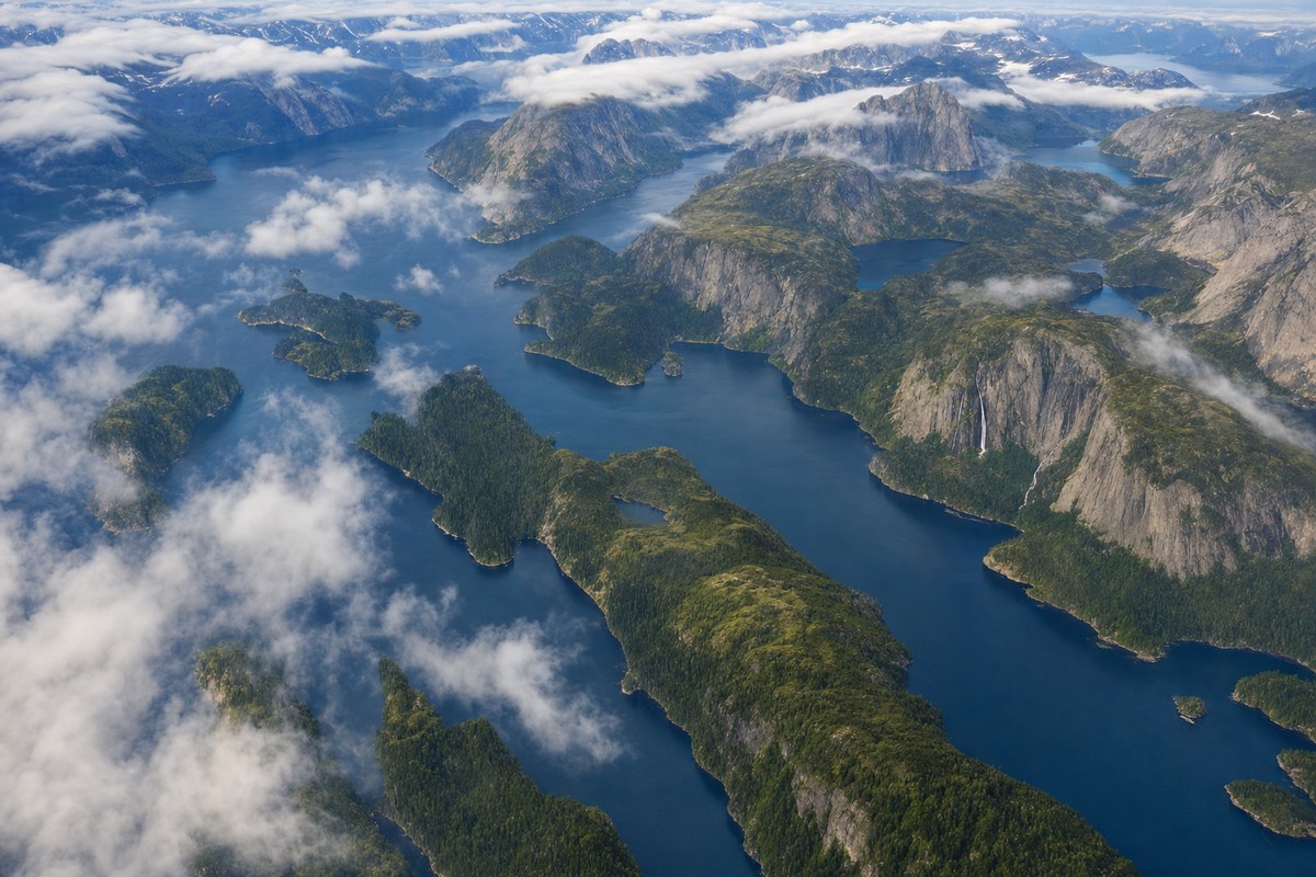 Branching waterways, forested islands, lakes, and granite walls across Misty Fjords