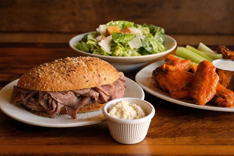 Contextual Western New York dinner with beef on weck and wings