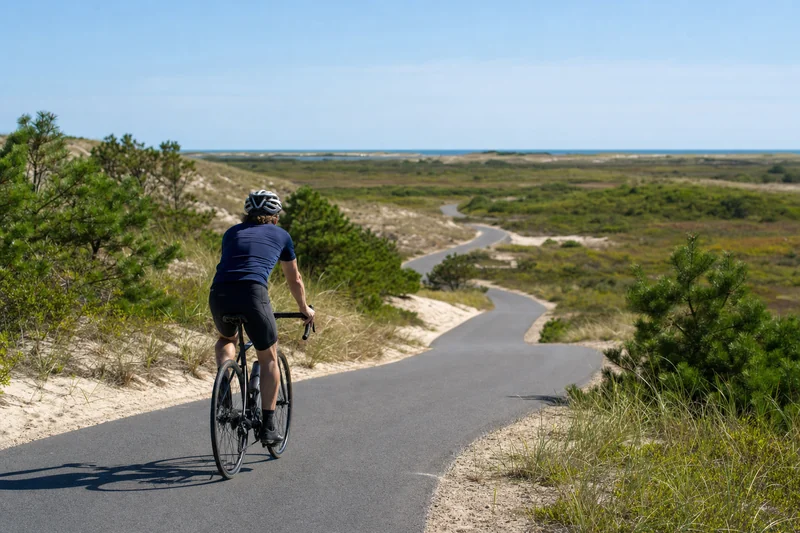 Helmeted cyclist on the paved Province Lands bicycle trail