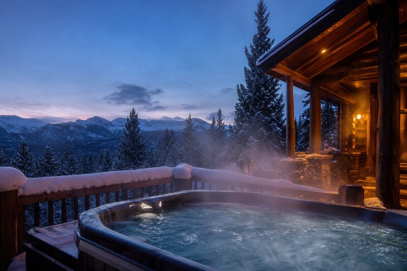 Outdoor hot tub at a snowy Red Lodge cabin after skiing