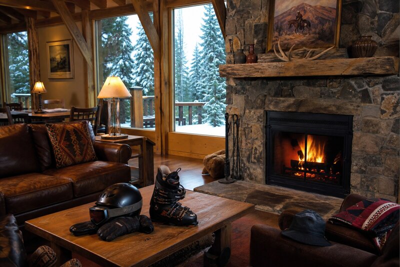 Cozy Ruidoso cabin lounge with fireplace and ski gear