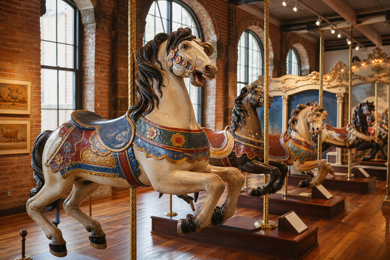 Carousel artisan working on a painted wooden horse