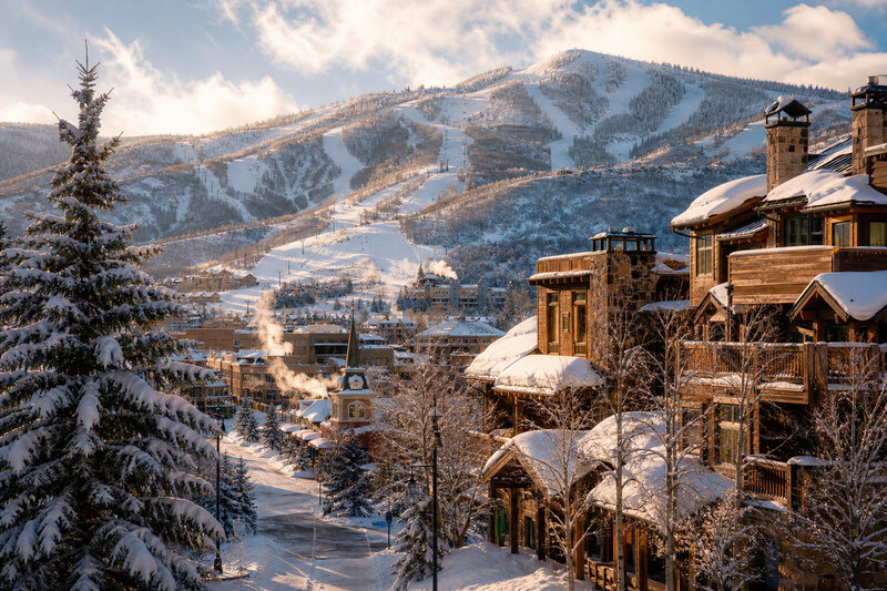 Steamboat ski resort champagne powder snow skiers on mountain blue sky