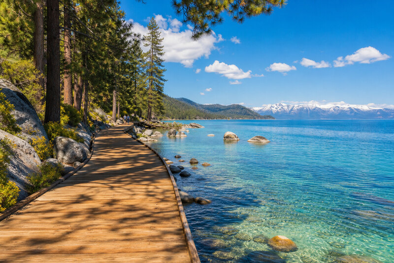 Sunny Tahoe City beach with boardwalk and blue water