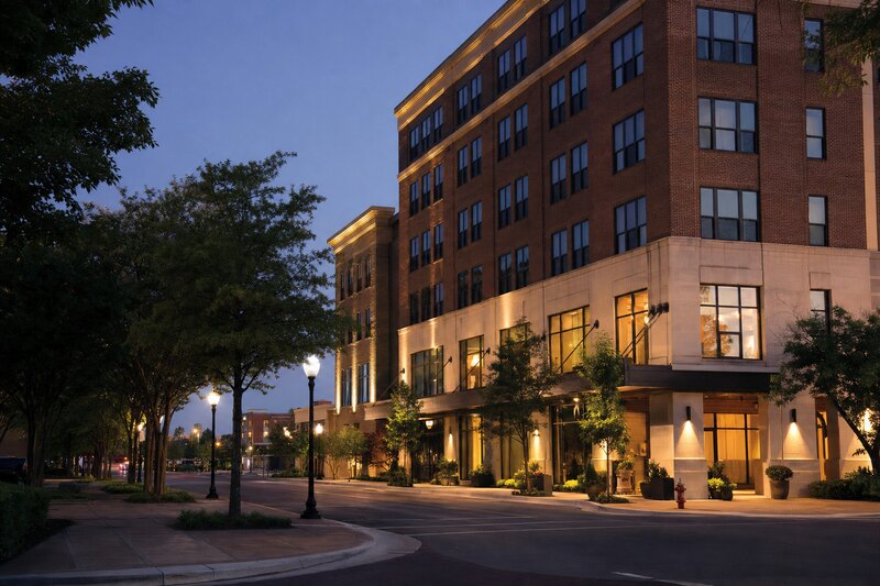 Contextual downtown Tuscaloosa lodging-district streetscape at blue hour