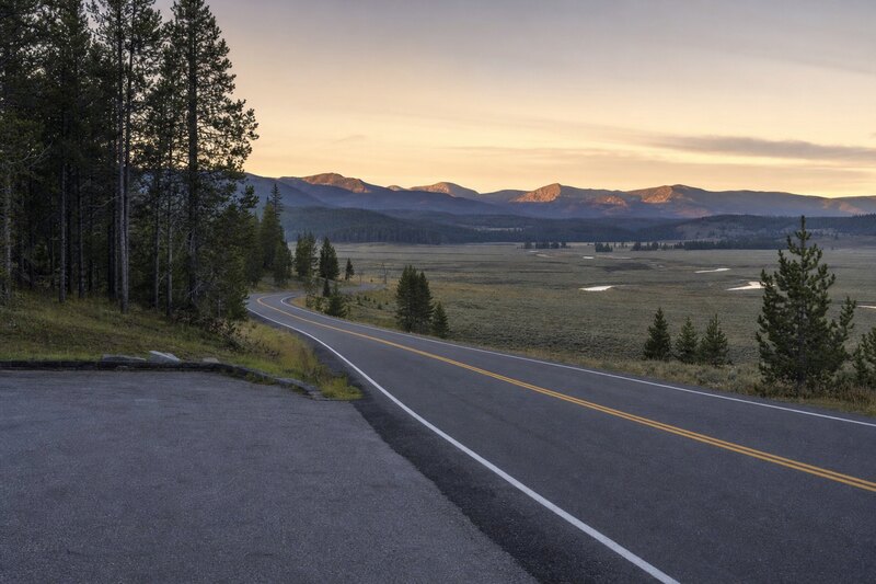 Contextual mountain road approaching Yellowstone country